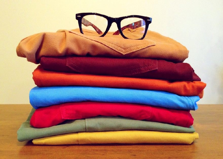 A pair of black glasses on a pile of clothes