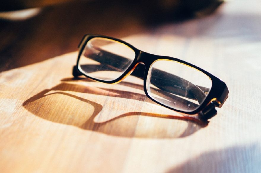 Black glasses on wooden table