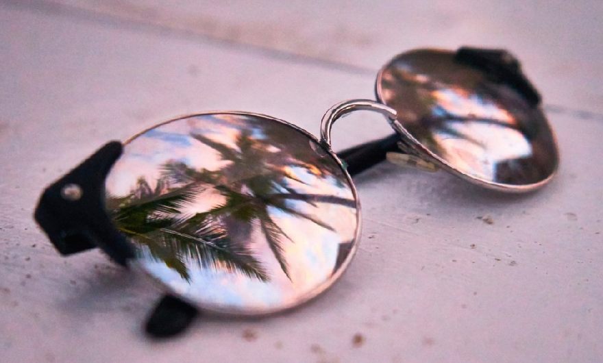 Sunglasses with reflected palm trees