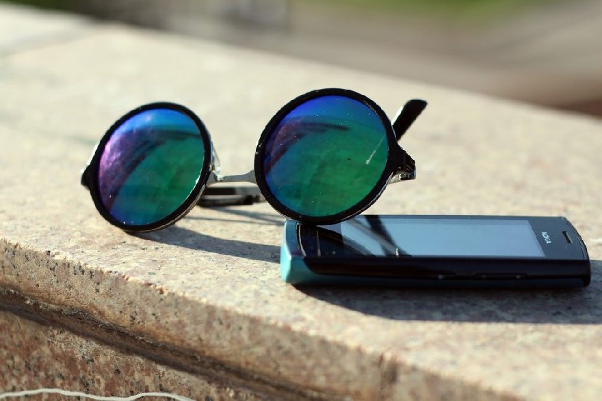 Sunglasses and an old cell phone