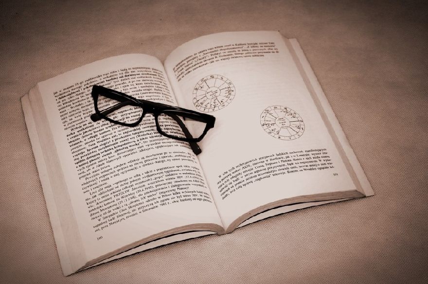 Black glasses on an open book