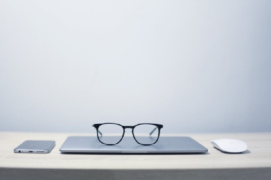 Black glasses on a laptop