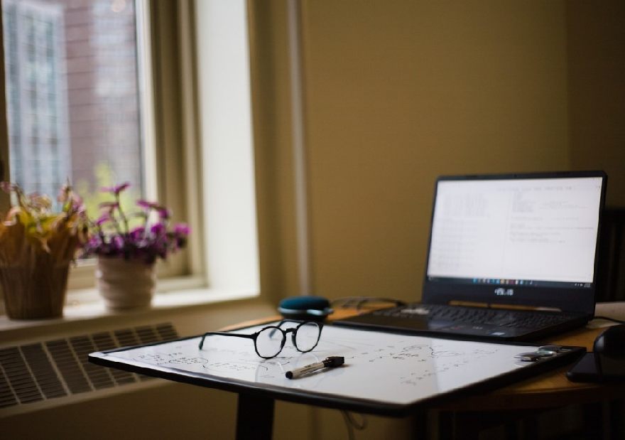 Glasses with laptop on a table