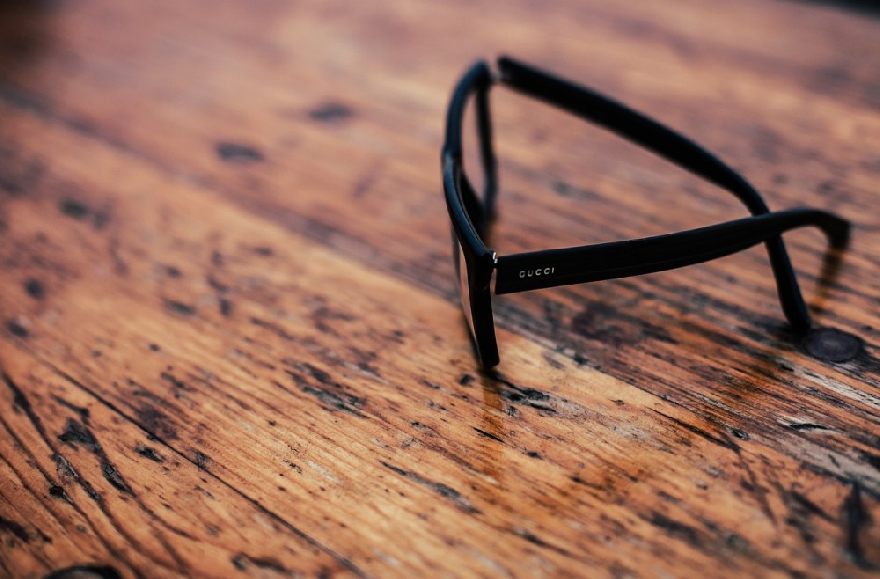 Gucci glasses on an old wooden table